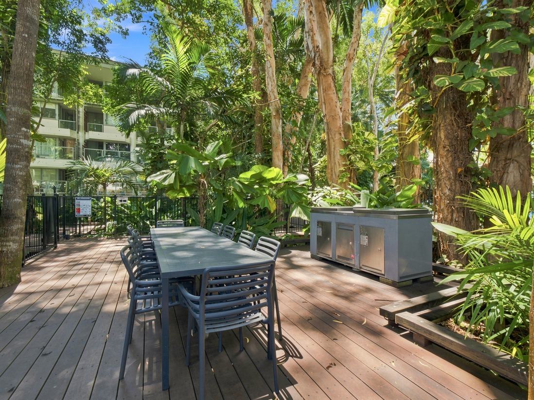 Outdoor BBQ and dining deck under rainforest canopy