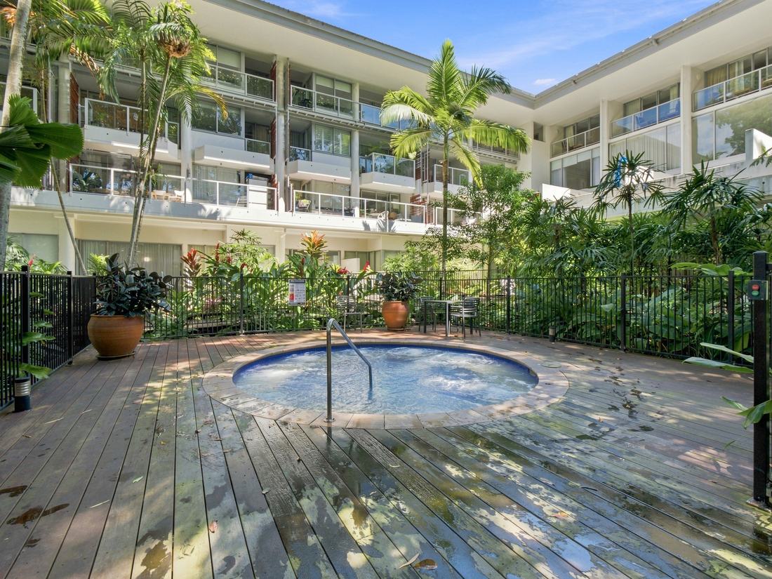 Resort apartment building above a tropical spa and deck
